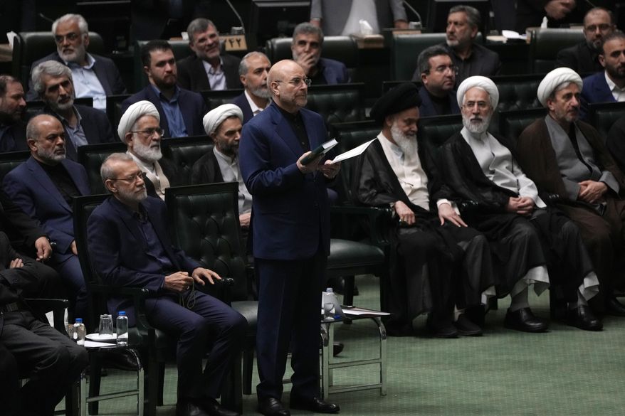 Mohammad Bagher Qalibaf, center, takes an oath during the opening ceremony of the new Parliament term in Tehran, Iran, Monday, May 27, 2024. Iran's Parliament reelected hard-liner Qalibaf on Tuesday as its speaker, reaffirming its hard-right makeup in the wake of a helicopter crash that killed the country's president and foreign minister. (AP Photo/Vahid Salemi)