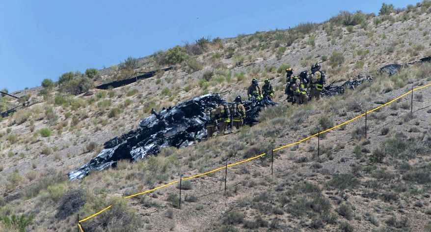 Emergency workers respond to a military plane crash near the Albuquerque International Airport, Tuesday, May 28, 2024, in Albuquerque, N.M. The pilot escaped the plane before it crashed. (Eddie Moore/The Albuquerque Journal via AP)