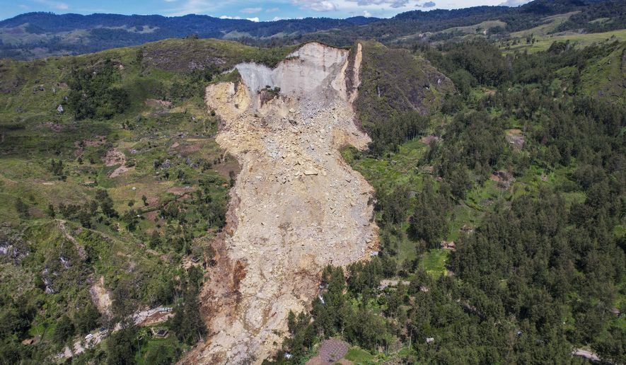 This photo released by UNDP Papua New Guinea, shows a landslide in Yambali village, in the Highlands of Papua New Guinea, Monday, May 27, 2024. Authorities fear a second landslide and a disease outbreak are looming at the scene of Papua New Guinea's recent mass-casualty disaster because of water streams trapped beneath tons of debris and decaying corpses seeping downhill following the May 24 landslide. (Juho Valta/UNDP Papua New Guinea via AP)