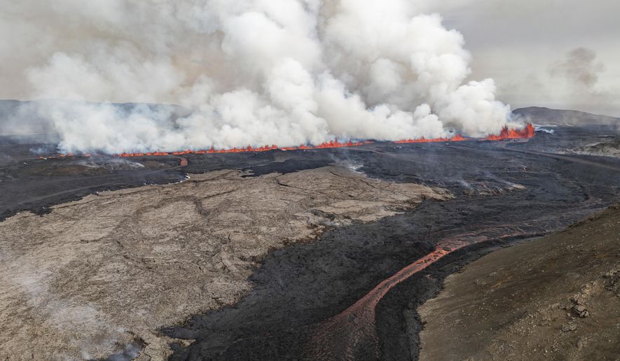 An eruptive fissure spews lava and smoke from a volcano in Grindavik, Iceland, Wednesday, May 29, 2024. A volcano in southwestern Iceland erupted Wednesday for the fifth time since December, spewing red lava that once again threatened the coastal town of Grindavik and led to the evacuation of the popular Blue Lagoon geothermal spa. (AP Photo/Marco di Marco)