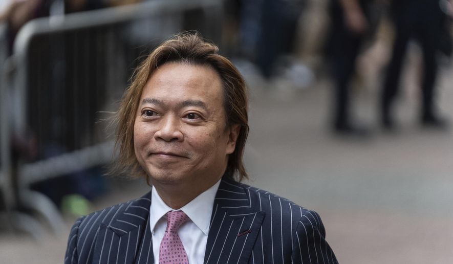 Lawrence Lau, a former pro-democracy district councilor, arrives at the West Kowloon Magistrates' Courts in Hong Kong, Thursday, May 30, 2024. (AP Photo/Chan Long Hei)