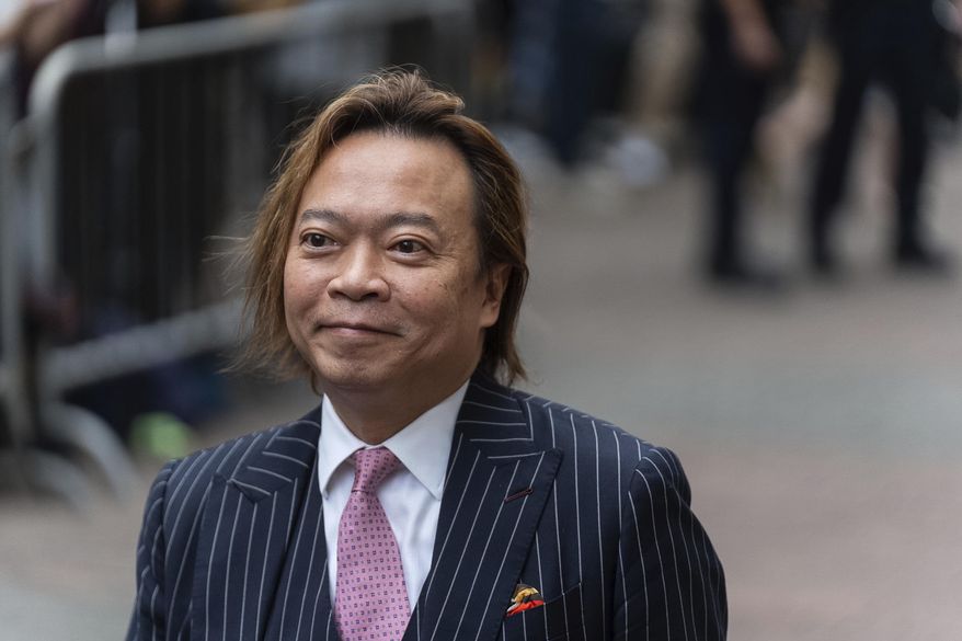 Lawrence Lau, a former pro-democracy district councilor, arrives at the West Kowloon Magistrates' Courts in Hong Kong, Thursday, May 30, 2024. (AP Photo/Chan Long Hei)