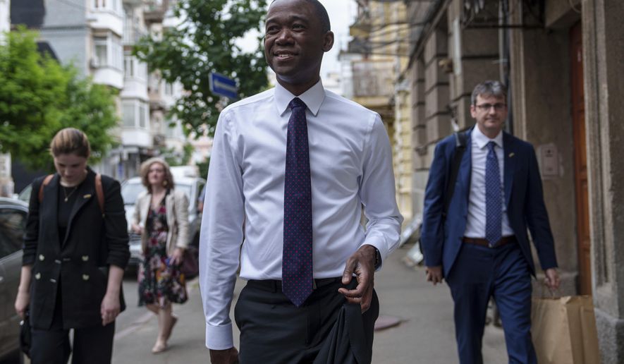 United States Deputy Treasury Secretary Wally Adeyemo walks in the city center during an official visit to Kyiv, Ukraine, on Wednesday, May 29, 2024. (AP Photo/Evgeniy Maloletka)