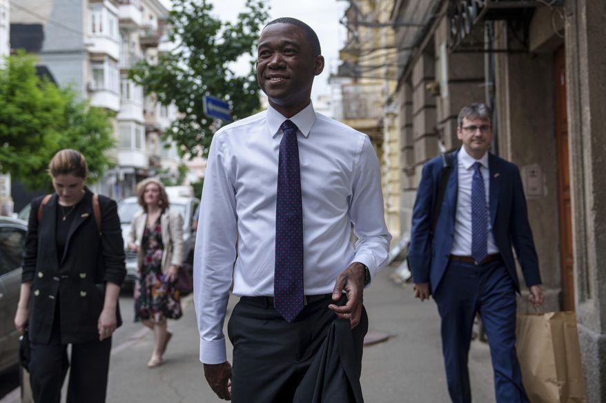 United States Deputy Treasury Secretary Wally Adeyemo walks in the city center during an official visit to Kyiv, Ukraine, on Wednesday, May 29, 2024. (AP Photo/Evgeniy Maloletka)