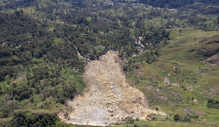 In this image taken from video, drone footage shows the landslide in Yambali village, in the Highlands of Papua New Guinea, Monday, May 27, 2024. Emergency responders say that up to 8,000 people might need to be evacuated as the mass of boulders, earth and splintered trees that crushed the village of Yambali in the nation's mountainous interior on Friday, May 24 becomes increasingly unstable. (Juho Valta/UNDP Papua New Guinea via AP)