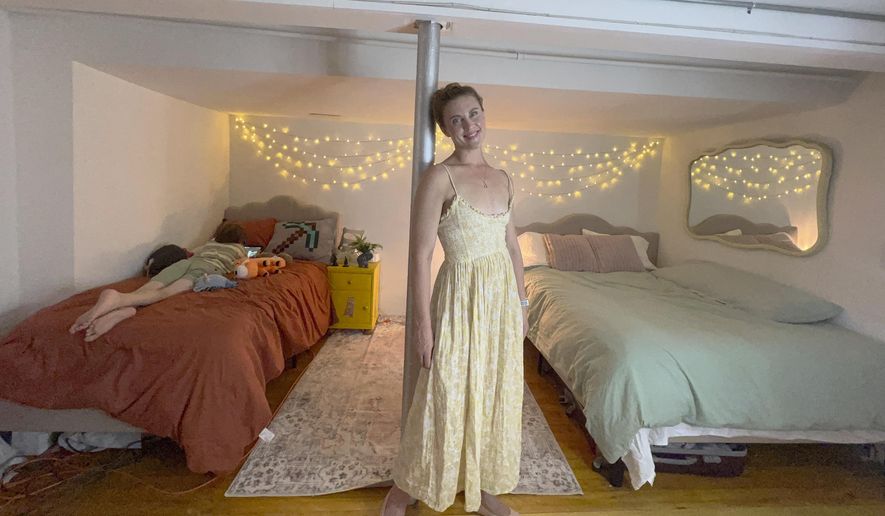 FILE - Erin Eloise Tulberg poses at home in the Brooklyn borough of New York on May 29, 2024, with her 9-year-old son. Tulberg set up a divorce registry after leaving her marriage with little more than her clothes and her books. (Erin Eloise Tulberg via AP)