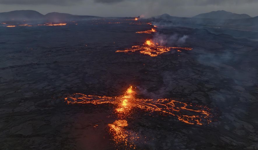 Eruptive fissures spew lava and smoke from a volcano in Grindavik, Iceland, Wednesday, May 29, 2024. A volcano in southwestern Iceland erupted Wednesday for the fifth time since December, spewing red lava that once again threatened the coastal town of Grindavik and led to the evacuation of the popular Blue Lagoon geothermal spa. (AP Photo/Marco di Marco)