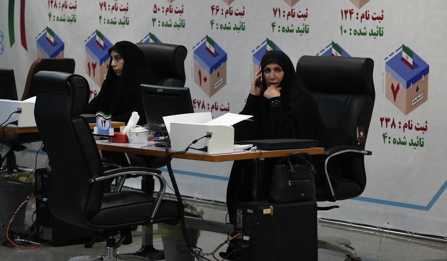 Iranian elections headquarters staff work to register candidates for the June 28 presidential elections at the Interior Ministry in Tehran, Iran, Thursday, May 30, 2024. Iran opened a five-day registration period Thursday for hopefuls wanting to run in the presidential election to replace the late Ebrahim Raisi, who was killed in a helicopter crash earlier this month with seven others. (AP Photo/Vahid Salemi)