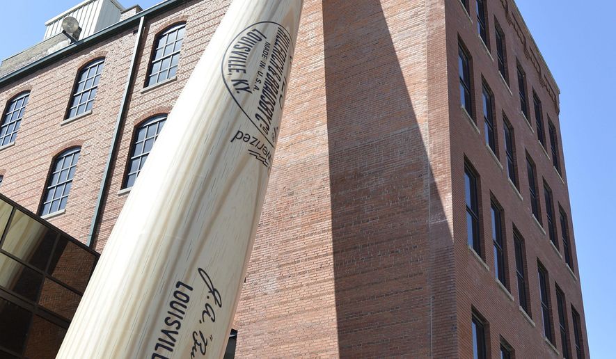 In this March 23, 2015 file photo, a 120-foot-tall replica bat fronts the Louisville Slugger Museum and Factory in Louisville, Ky. Kentucky's tourism industry stayed on its record-setting pace in 2023, generating an economic impact approaching $14 billion while sustaining nearly 100,000 jobs, Gov. Andy Beshear said Thursday, May 30, 2024. (AP Photo/Timothy D. Easley, File)