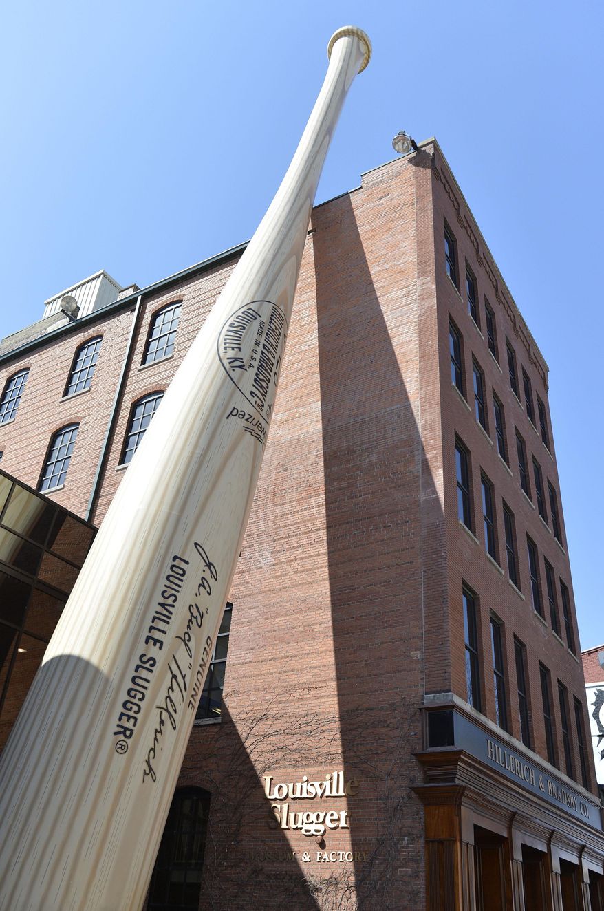 In this March 23, 2015 file photo, a 120-foot-tall replica bat fronts the Louisville Slugger Museum and Factory in Louisville, Ky. Kentucky's tourism industry stayed on its record-setting pace in 2023, generating an economic impact approaching $14 billion while sustaining nearly 100,000 jobs, Gov. Andy Beshear said Thursday, May 30, 2024. (AP Photo/Timothy D. Easley, File)
