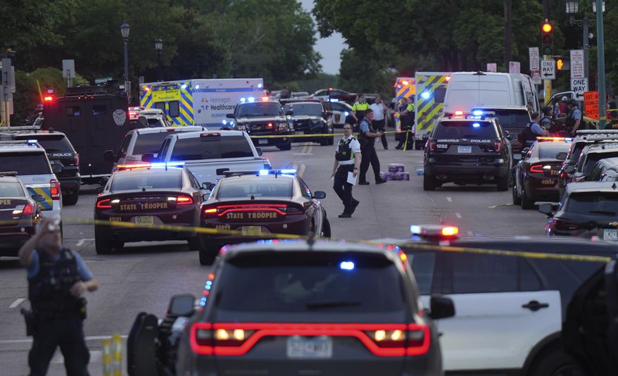Investigators examine the scene of a shooting Thursday, May 30, 2024, in Minneapolis. Two Minneapolis police officers and four civilians were injured in south Minneapolis, Thursday in what officials are calling an active-shooter situation, law enforcement said. (Glen Stubbe/Star Tribune via AP)