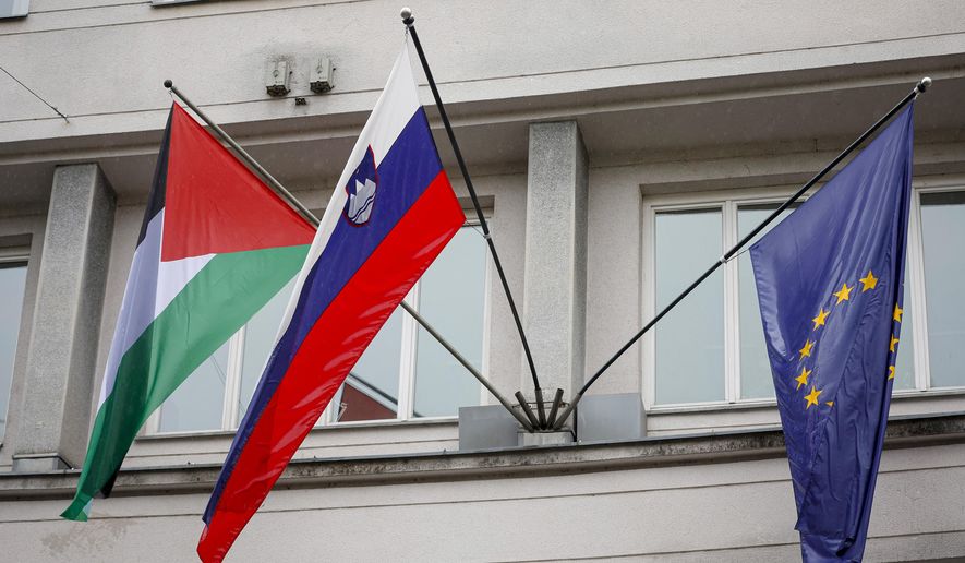 A Palestinian flag flies next to a Slovenian, center, and a European Union flag, right, at the government building in Ljubljana, Slovenia, Thursday, May 30, 2024. Slovenia’s government has endorsed a motion to recognize a Palestinian state and sent it to parliament for approval. Prime Minister Robert Golob's ruling liberal coalition has a comfortable majority in the 90-member assembly and the vote should be formality. The decision by the Slovenian government on Thursday comes just two days after Spain, Norway and Ireland recognized a Palestinian state. It was a move that was slammed by Israel. (AP Photo)