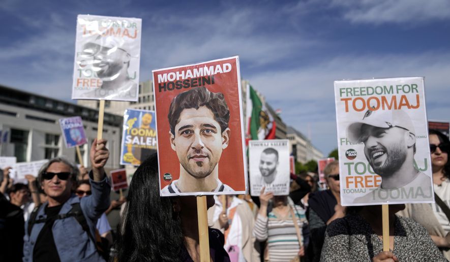 Protesters attend a rally against a death sentence given to a popular rapper in Iran and to support the women of Iran, in Berlin, Germany, April 28, 2024. (AP Photo/Ebrahim Noroozi, File)