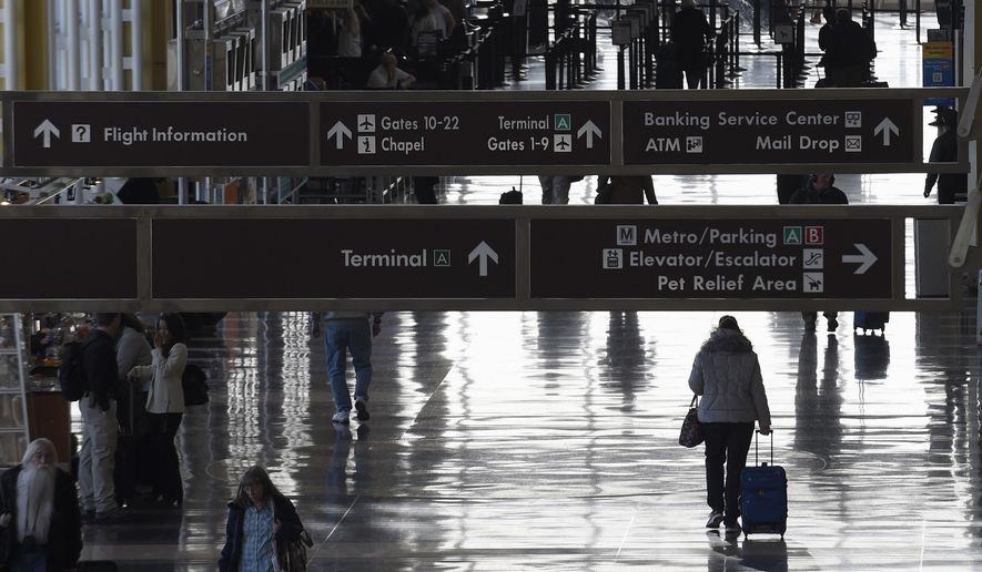 People walk the terminal at Washington's Ronald Reagan National Airport, Monday, Jan. 25, 2016. Federal officials are looking into yet another close call between planes, this one at Reagan National Airport. An American Airlines plane had to cancel its takeoff to avoid colliding with another plane that was landing on an intersecting runway. The Federal Aviation Administration says it's investigating the incident Wednesday, May 29, 2024. (AP Photo/Susan Walsh, File)