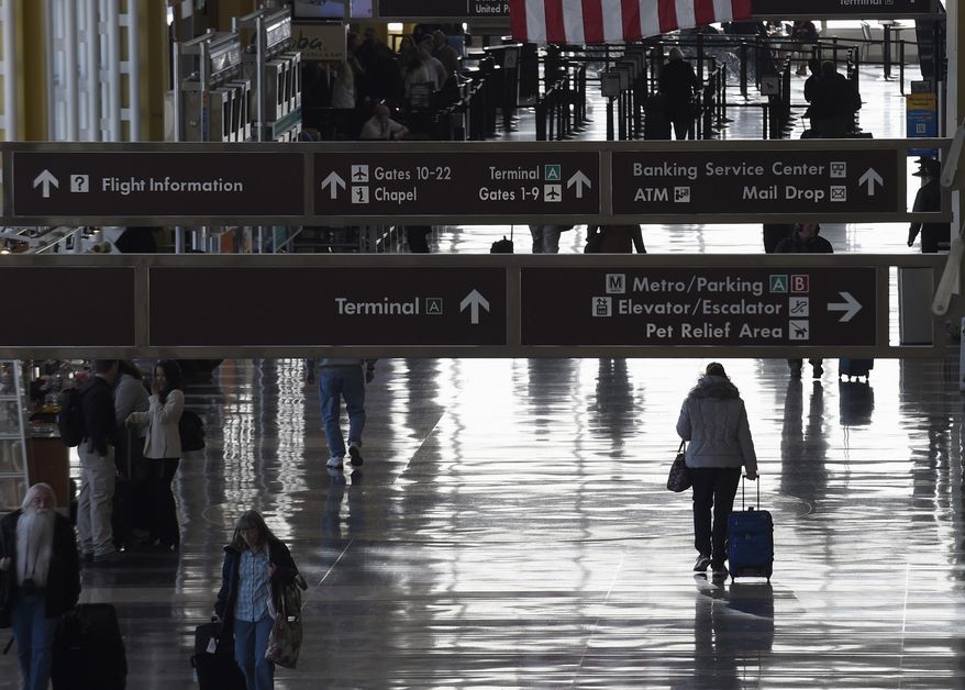 People walk the terminal at Washington's Ronald Reagan National Airport, Monday, Jan. 25, 2016. Federal officials are looking into yet another close call between planes, this one at Reagan National Airport. An American Airlines plane had to cancel its takeoff to avoid colliding with another plane that was landing on an intersecting runway. The Federal Aviation Administration says it's investigating the incident Wednesday, May 29, 2024. (AP Photo/Susan Walsh, File)