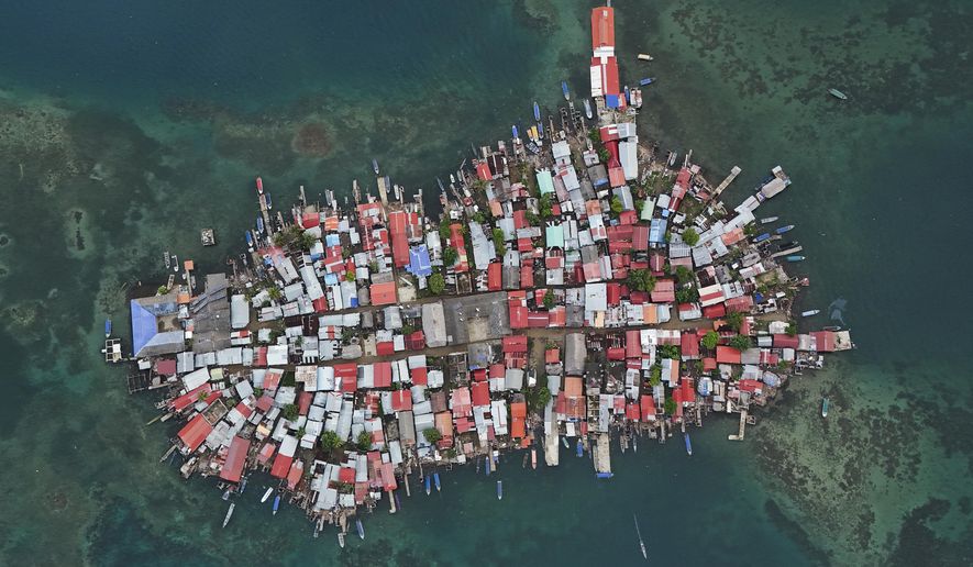 Buildings cover Gardi Sugdub Island, part of San Blas archipelago off Panama's Caribbean coast, Saturday, May 25, 2024. Due to rising sea levels, about 300 Guna Indigenous families will relocate to new homes, built by the government, on the mainland. (AP Photo/Matias Delacroix)