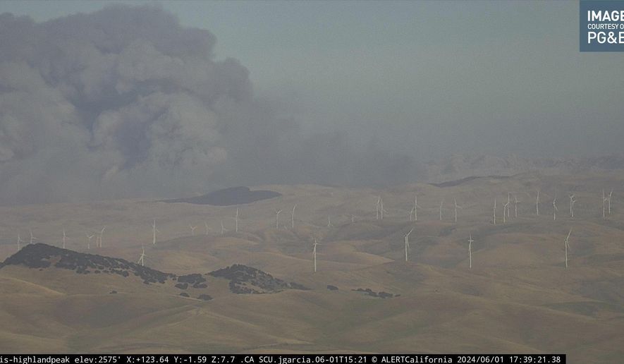 In this image from an AlertCalifornia/UC San Diego monitoring camera, smoke rises from the Corral Fire near the city of Tracy, Calif., Saturday, June 1, 2024. (AlertCalifornia/UC San Diego via AP)