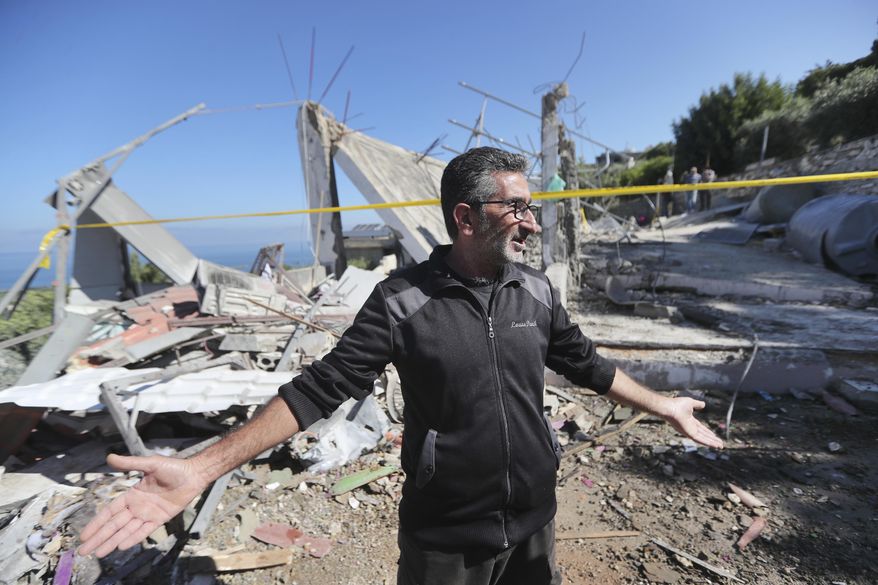 A Lebanese man gestures as he inspects a destroyed house that was hit on Friday night by an Israeli airstrike, killing one woman and wounding several other people, in the southern village of Adloun, Lebanon, Saturday, June 1, 2024. The militant Hezbollah group shot down Saturday an Israeli Hermes 900 Kochav drone over south Lebanon, after hours of Israeli drones strikes that killed at least one person and wounded others. (AP Photo/Mohammad Zaatari)