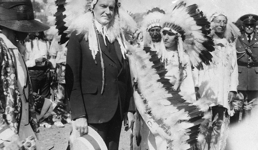 U.S. President Calvin Coolidge wears a Native American headdress of the Sioux tribe as he is adopted as Chief Leading Eagle and first white chief of the tribe at the celebration of the 51st anniversary of the settlement of Deadwood, South Dakota, in 1927. Coolidge signed the Indian Citizenship Act of 1924. (AP Photo/File)
