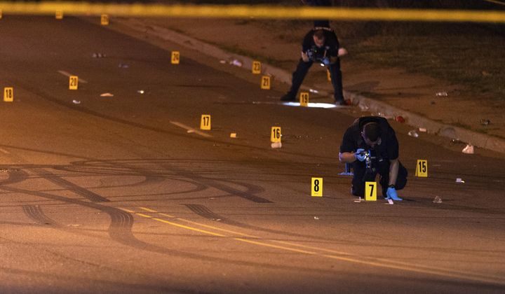 This image, courtesy of News 5 Cleveland, shows officers of the Akron Police Department investigating a shooting that happened overnight in Akron, Ohio, Sunday, June 2, 2024. (Mike Vielhaber/News 5 Cleveland via AP)