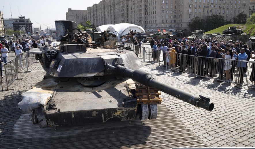 Representatives of the diplomatic corps look at U.S.-made M1 Abrams tank, and other U.S. military vehicles, hit and captured by Russian troops during the fighting in Ukraine as they visit an exhibition of Western military equipment seized from Ukrainian forces, in Moscow, on Friday, May 31, 2024. The exhibit, organized by the Russian Defense Ministry, features more than 30 pieces of Western-made heavy equipment, including a U.S.-made M1 Abrams tank and a Bradley armored fighting vehicle. (AP Photo/Alexander Zemlianichenko)