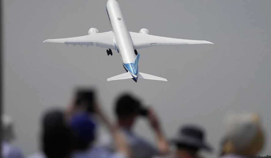 FILE - A Boeing 777X plane takes off at the Farnborough Air Show fair in Farnborough, England, on July 18, 2022. The cost of your next flight is likely to go up. That's the word from the International Air Transport Association, which held its annual meeting Monday June 3, 2024 in Dubai, home to the long-haul carrier Emirates. (AP Photo/Frank Augstein, File)