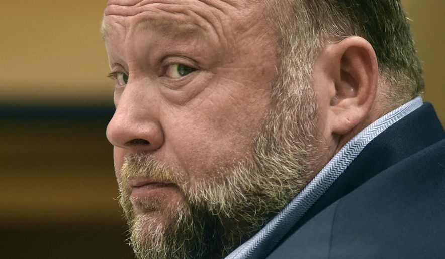Infowars founder Alex Jones appears in court to testify during the Sandy Hook defamation damages trial at Connecticut Superior Court, Sept. 22, 2022, in Waterbury, Conn. Relatives of victims of the Sandy Hook Elementary School shooting are asking a bankruptcy judge to liquidate Jones' media company including Infowars instead of allowing him to reorganize his business, as they seek to collect on $1.5 billion in lawsuit verdicts against him. (Tyler Sizemore/Hearst Connecticut Media via AP, Pool, File)