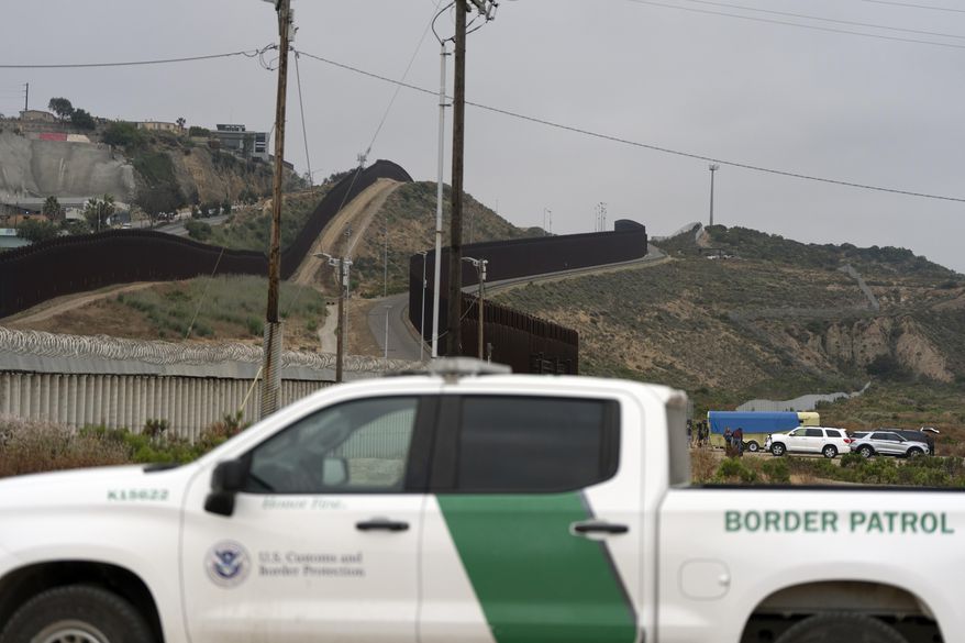 A Border Patrol vehicle sits near border walls separating Tijuana, Mexico, from the United States, Tuesday, June 4, 2024, in San Diego. (AP Photo/Gregory Bull) ** FILE **