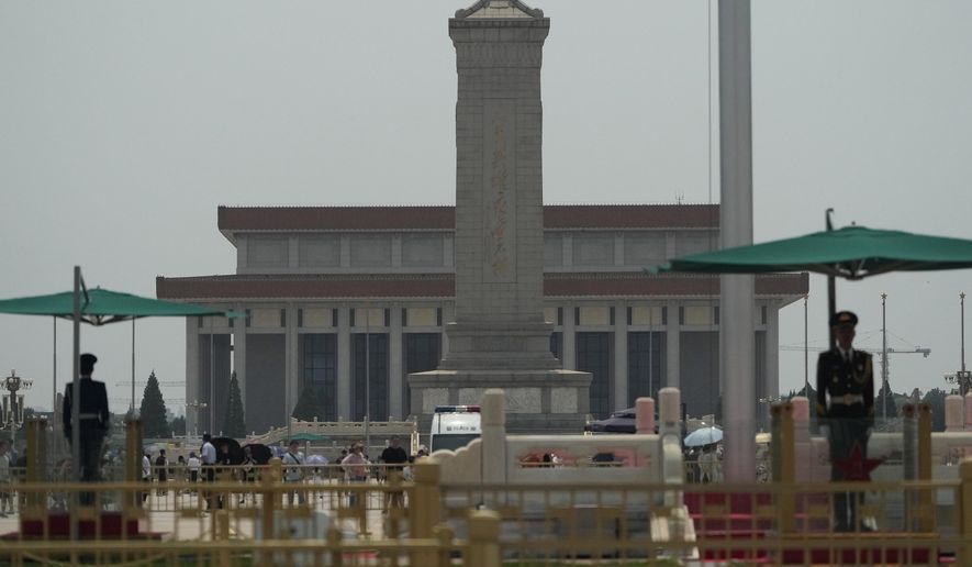 Chinese paramilitary policemen stand on duty at the flag pole near the Monument to the People's Heroes on Tiananmen Square in Beijing, Tuesday, June 4, 2024. Checkpoints and rows of police vehicles lined a major road leading to Beijing's Tiananmen Square as China heightened security on the 35th anniversary of a bloody crackdown on pro-democracy protests. (AP Photo/Ng Han Guan)