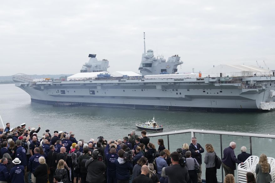 British Normandy veterans wave to the crowds and to the aircraft carrier HMS Prince of Wales that has its sides lined with sailors as they depart Portsmouth Harbour on board the Mont St Michael ferry to France, in Portsmouth, England, Tuesday, June 4, 2024. (AP Photo/Alastair Grant) ** FILE **