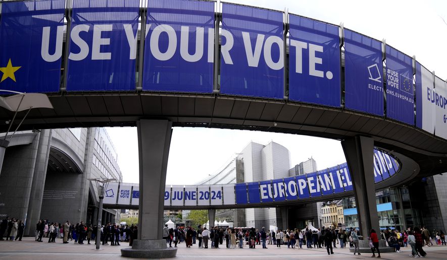 FILE - People wait in line to visit the European Parliament during Europe Day celebrations in Brussels on May 4, 2024. Voters in the European Union are set elect lawmakers for the bloc's parliament, in a major democratic exercise that's also likely to be overshadowed by online disinformation. Experts have warned about that artificial intelligence could supercharge the spread of fake news to disrupt the election in the EU and many other countries this year. (AP Photo/Virginia Mayo, File)