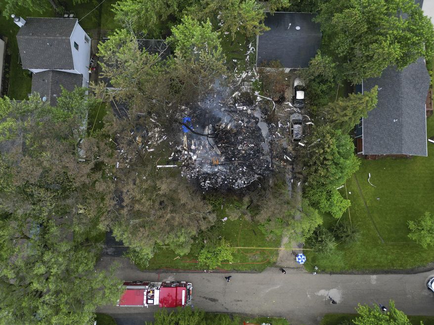 Smoke still rises from the aftermath of a home explosion in unincorporated Lake Zurich, Ill., Wednesday, June 5, 2024. First responders found the home leveled after an explosion about 8:30 p.m. Tuesday in according to the Lake County sheriff's office. (Stacey Wescott/Chicago Tribune via AP)