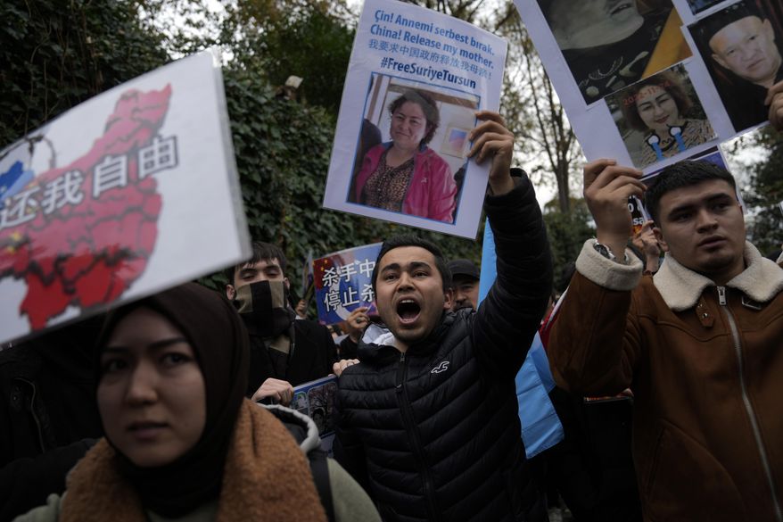FILE - Protesters chant slogans as they hold posters and pictures of victims during a protest against China's brutal crackdown on ethnic group Uyghurs, in front of the Chinese consulate in Istanbul, Turkey, Wednesday, Nov. 30, 2022. Turkey's foreign minister has urged Chinese authorities to protect the cultural rights of minority Muslim Uyghurs in China's western Xinjiang province and allow them to "live their values," a Turkish official said Wednesday, June 5, 2024. (AP Photo/Khalil Hamra, File)