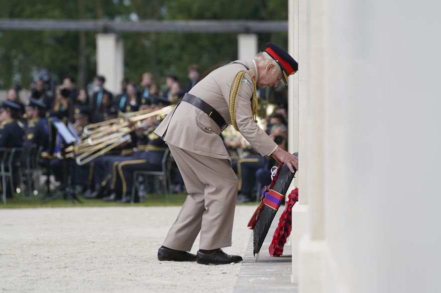 King Charles III lays a wreath during the UK national commemorative event for the 80th anniversary of D-Day, held at the British Normandy Memorial in Ver-sur-Mer, Normandy, France, Thursday June 6, 2024. (Gareth Fuller, Pool Photo via AP)