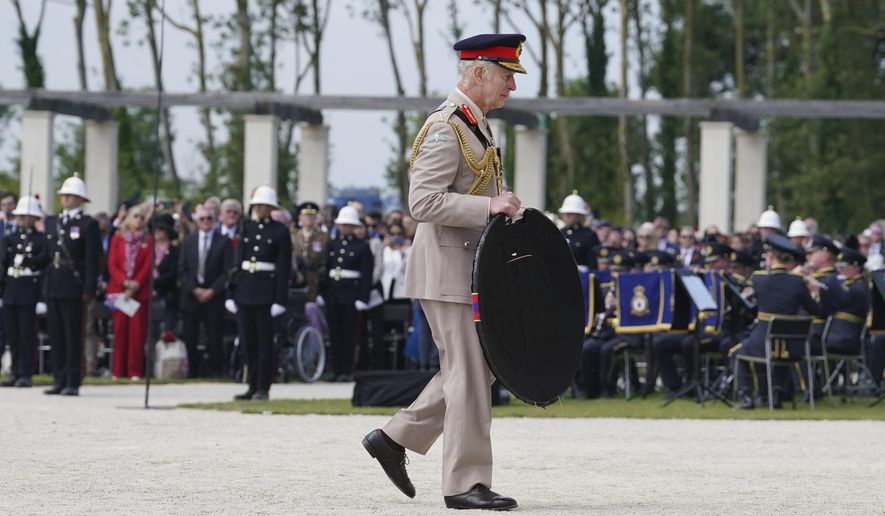 King Charles III lays a wreath during the UK national commemorative event for the 80th anniversary of D-Day, held at the British Normandy Memorial in Ver-sur-Mer, Normandy, France, Thursday June 6, 2024. (Gareth Fuller, Pool Photo via AP)