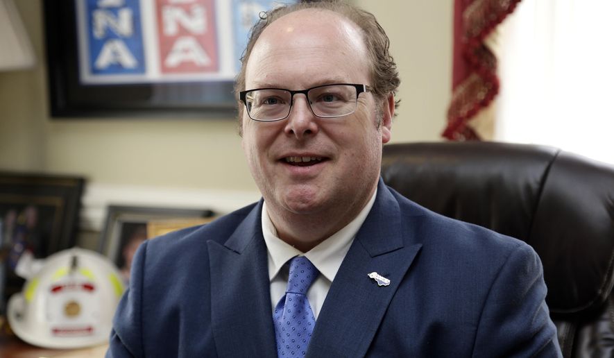Then State Democratic Party Chairman Wayne Goodwin speaks with an aide in his office at the Democratic party headquarters in Raleigh, N.C., April 5, 2020. Goodwin, the state's now DMV commissioner, told lawmakers on Thursday, June 6, 2024, that he anticipates the backlog to be eliminated by the end of June. More than 350,000 physical licenses and identification cards have recently been delayed for up to eight weeks. (AP Photo/Gerry Broome, File)