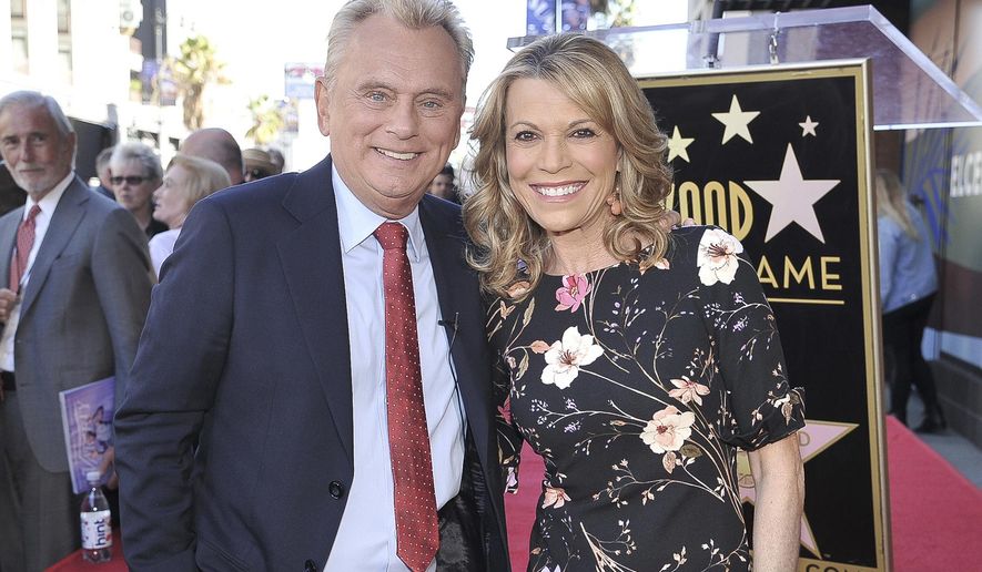 Pat Sajak, left, and Vanna White, from "Wheel of Fortune," attend a ceremony honoring Harry Friedman with a star on the Hollywood Walk of Fame in Los Angeles on Nov. 1, 2019. (Photo by Richard Shotwell/Invision/AP, File)