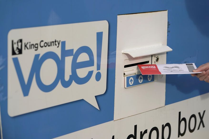 A person puts their ballot in a drop box on Oct. 27, 2020, at a library in Seattle. A Washington state judge on Friday, June 7, 2024, turned back an attempt by GOP backers of three initiatives to keep the fiscal impact of the measures off the November ballot. (AP Photo/Ted S. Warren, File)
