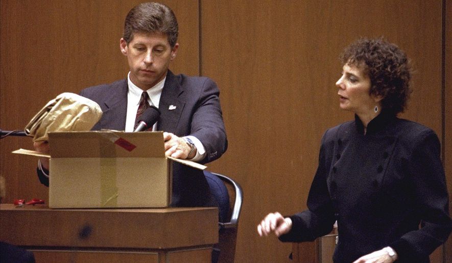 Los Angeles Police Detective Mark Fuhrman shows the jury in the O.J. Simpson double murder trial evidence during testimony Friday, March 10, 1995, in Los Angeles. Fuhrman, 72, who was convicted of lying on the witness stand in the O.J. Simpson trial three decades ago, is now barred from law enforcement under a California police reform law meant to strip the badges of police officers who act criminally or with bias. (AP Photo/Nick Ut, Pool, File)
