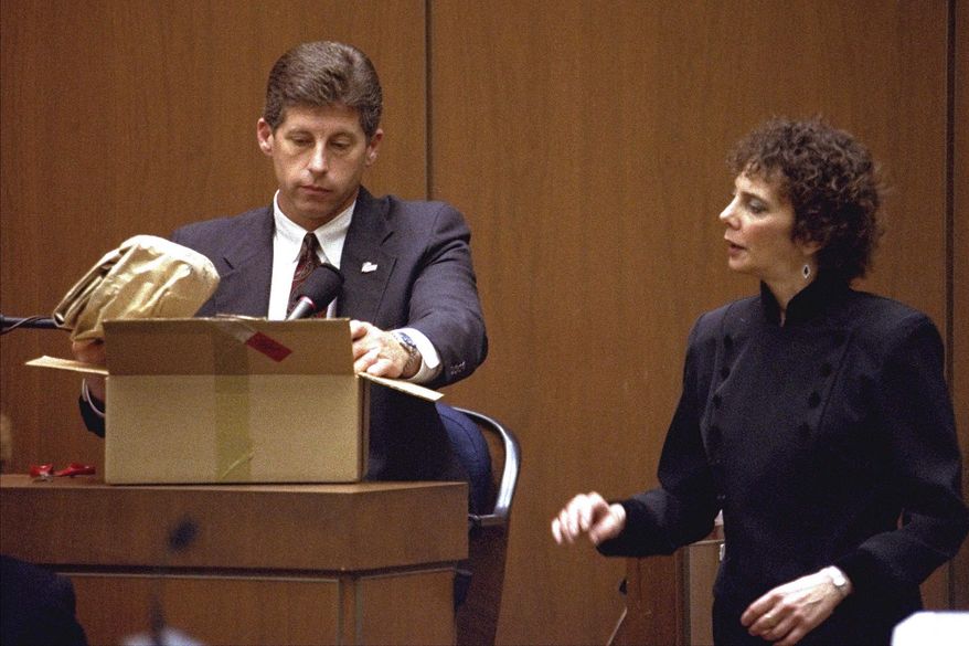 Los Angeles Police Detective Mark Fuhrman shows the jury in the O.J. Simpson double murder trial evidence during testimony Friday, March 10, 1995, in Los Angeles. Fuhrman, 72, who was convicted of lying on the witness stand in the O.J. Simpson trial three decades ago, is now barred from law enforcement under a California police reform law meant to strip the badges of police officers who act criminally or with bias. (AP Photo/Nick Ut, Pool, File)