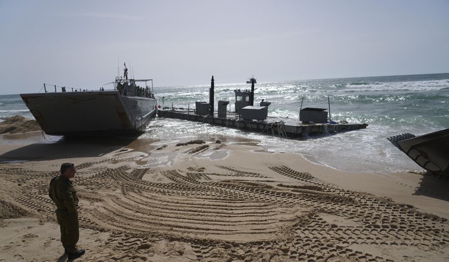 A U.S. Army landing craft is seen beached in Ashdod, May 26, 2024, after being swept by wind and current from the temporary humanitarian pier in the Gaza Strip. A key section of the U.S. military-built pier designed to carry badly needed aid into Gaza by boat has been reconnected to the Gaza beach following storm damage repairs and aid will begin to flow soon, the U.S. Central Command announced Friday. (AP Photo/Tsafrir Abayov, File)