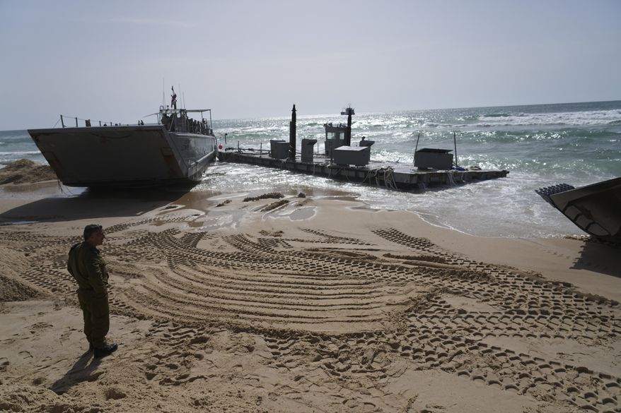 A U.S. Army landing craft is seen beached in Ashdod, May 26, 2024, after being swept by wind and current from the temporary humanitarian pier in the Gaza Strip. A key section of the U.S. military-built pier designed to carry badly needed aid into Gaza by boat has been reconnected to the Gaza beach following storm damage repairs and aid will begin to flow soon, the U.S. Central Command announced Friday. (AP Photo/Tsafrir Abayov, File)