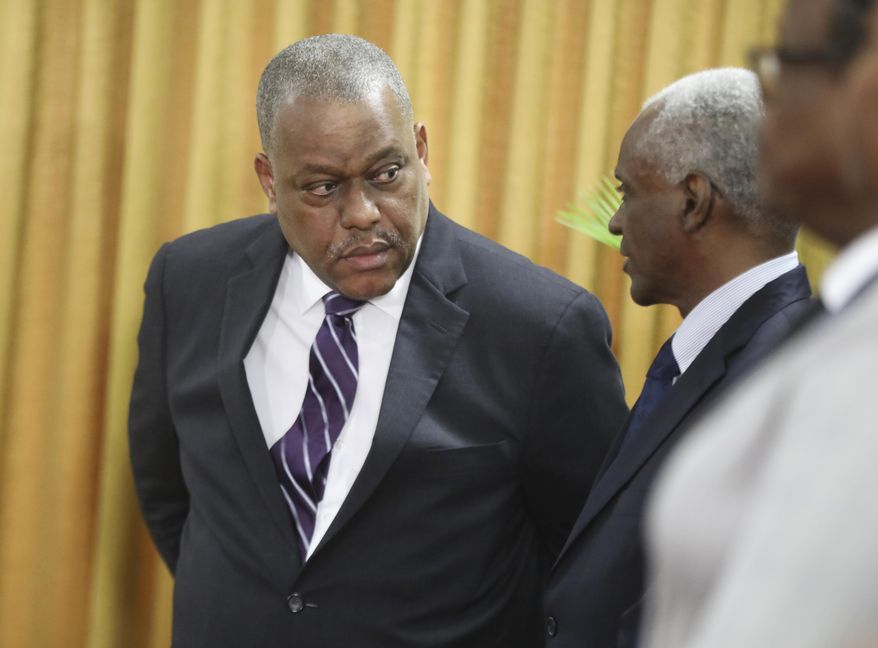 New Haitian Prime Minister Garry Conille, left, speaks to the president of the council Edgard Leblanc Fils during his swearing-in ceremony in Port-au-Prince, Haiti, Monday, June 3, 2024. (AP Photo/Odelyn Joseph)