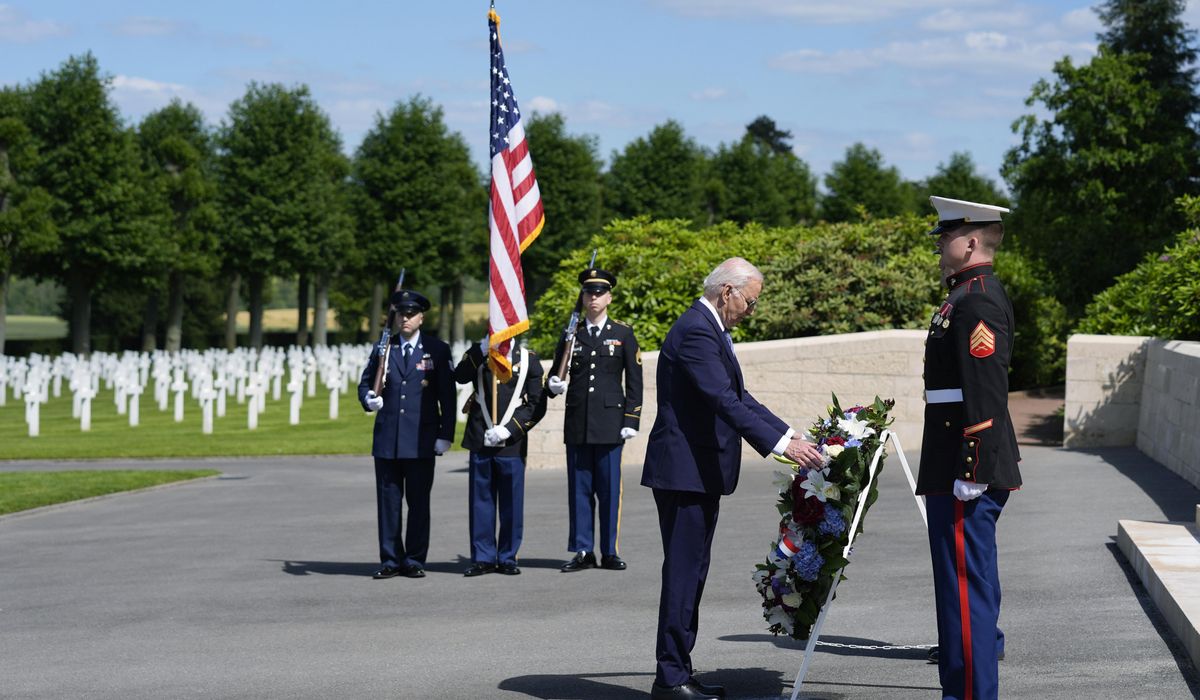 NextImg:Biden honors America’s war dead with a cemetery visit ending a trip that served as a rebuke to Trump