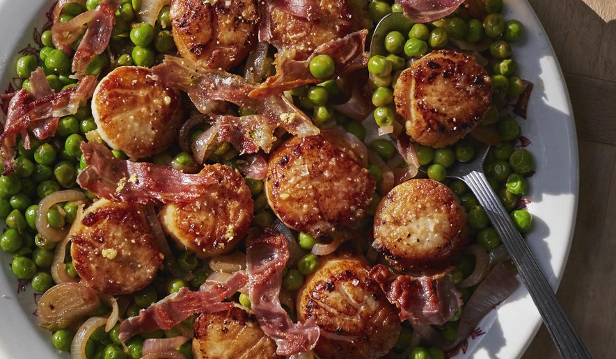 This image released by Weldon Owen shows a recipe for scallops with peas and prosciutto from the cookbook "Out There: A Camper Cookbook: Recipes from the Wild" by Lee Kalpakis. (Brittany Barb/Weldon Owen via AP)