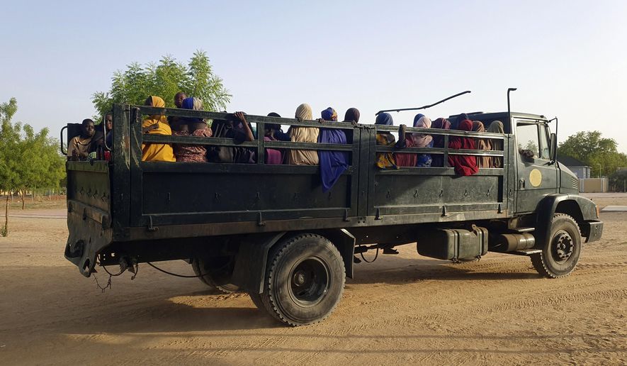 FILE - Women and children who were held captive by islamic extremists, and rescued by Nigeria's army, are seen upon arrival in Maiduguri, Nigeria, May 20, 2024. Dozens of women and young girls were unlawfully detained and abused in Nigerian military detention facilities after escaping captivity from Boko Haram extremists in the country’s northeast, Amnesty International said in a new report on Monday. (AP Photo/Jossy Olatunji, File)
