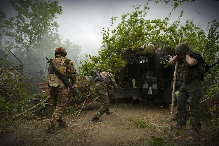 In this photo taken on Friday, April 26, 2024 and released by the Russian Defense Ministry Press Service, Russian soldiers fire a 2A65 "Msta-B" howitzer in an undisclosed location in Ukraine. (Russian Defense Ministry Press Service via AP)