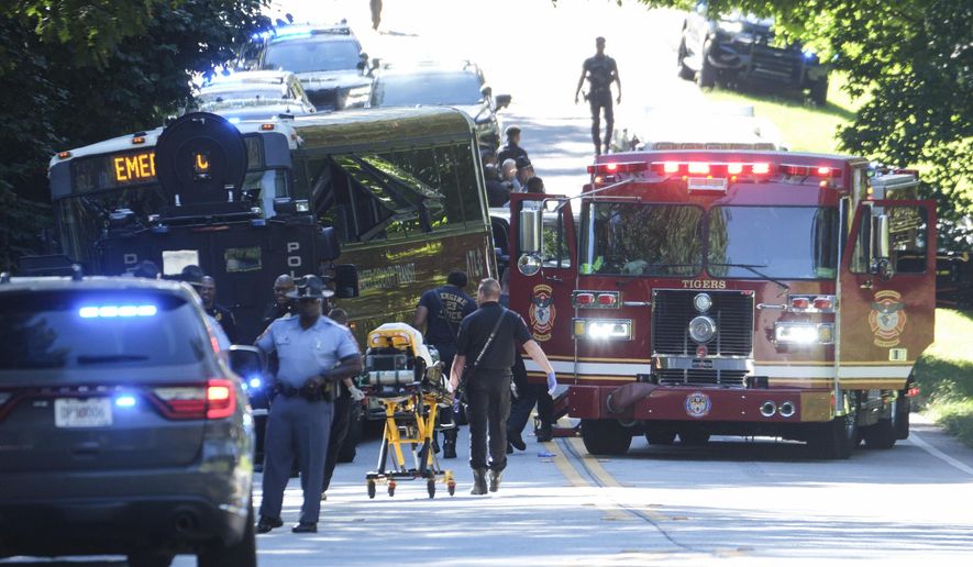 A Gwinnett County Ga. commuter bus sits in the road where it was stopped in Smoke Rise, Ga., on Tuesday, June 11, 2024. Atlanta police say the transit bus fled from officers responding to a dispute on board, leading them on a wild and lenthty chase into a neighboring county before it was stopped. (AP Photo/Ben Gray)