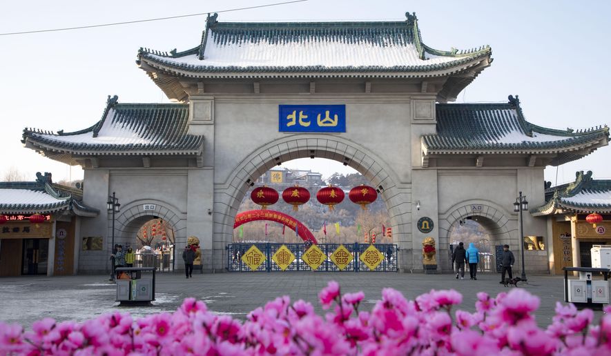 Tourists walk past a gateway with the name "Beishan" seen at the Beishan Park in northeastern China's Jilin province on Jan 23, 2020. Four instructors from Iowa's Cornell College teaching at Beihua University in northeastern China were attacked in the Beishan public park, reportedly with a knife, officials at the U.S. school and the State Department said Tuesday, June 11, 2024. (Zhu Wanchang/CNS Photos via AP)