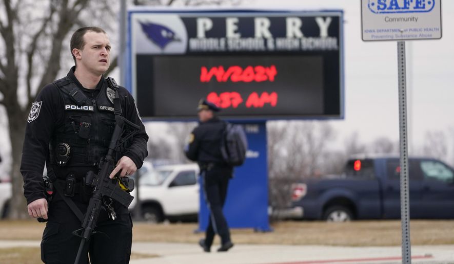 FILE - Police respond to Perry High School in Perry, Iowa, Jan. 4, 2024. Groups pushing tighter gun laws have been building political muscle through multiple elections, boosted by the outcry following mass shootings at schools and other public places, to say nothing of the nation's daily gun violence. Now, gun control advocates and many Democrats see additional openings created by hardline positions of the gun lobby and their most influential champion, former President Donald Trump. (AP Photo/Andrew Harnik, File)